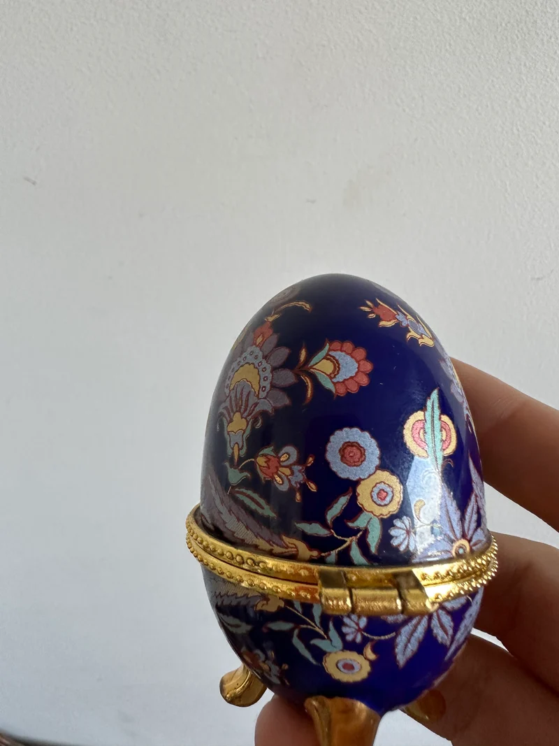 Oeuf en porcelaine sur pieds dorés