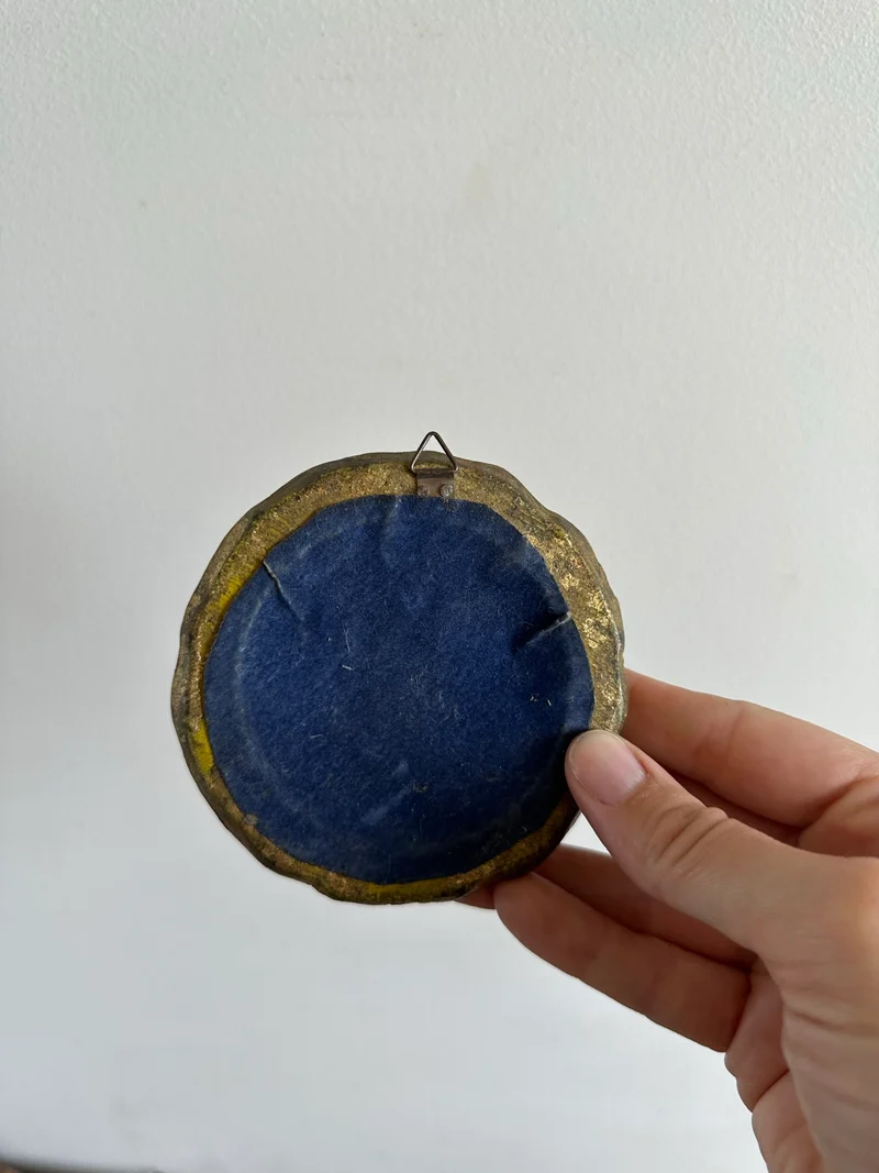 Médaillon en bois doré sculpté rond représentation jeune fille au chapeau