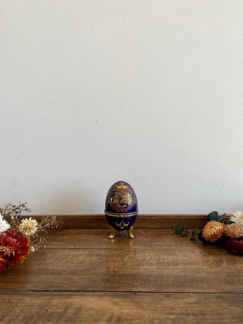 Oeuf en porcelaine sur pieds bleu marine et doré