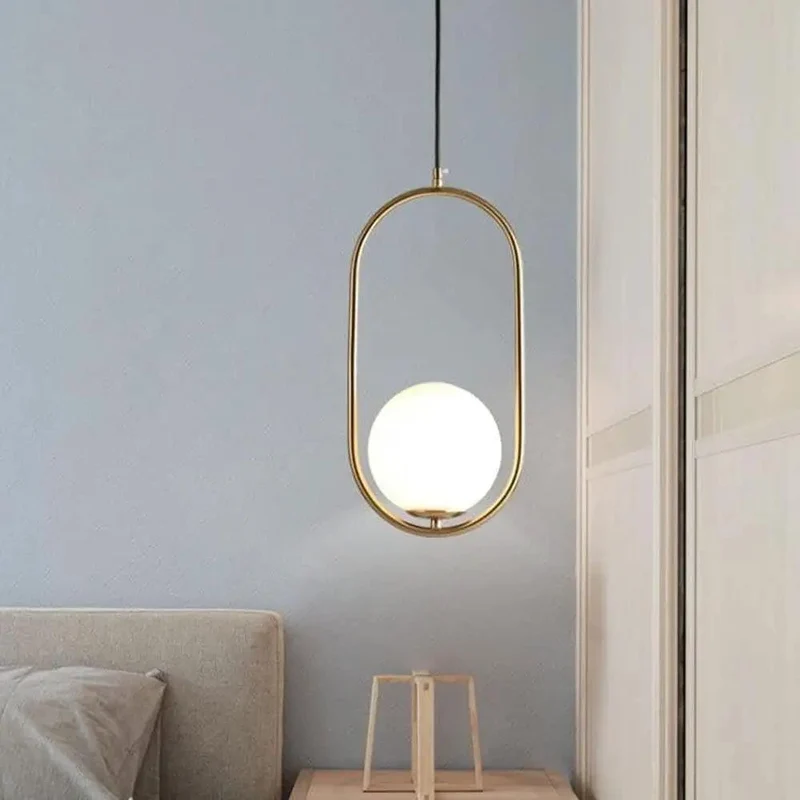 Sleek Oval Pendant Light Featuring Frosted White Glass Globe And Brushed Brass Frame Delivers Smooth Glare Free Illumination Perfect For Chic Bedroom Ambiance And Contemporary Living Room Setup Vibes